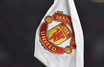 A corner flag showing the logo of Manchester United is seen ahead of the English FA Cup 4th round soccer match between Manchester United and Reading at Old Trafford.