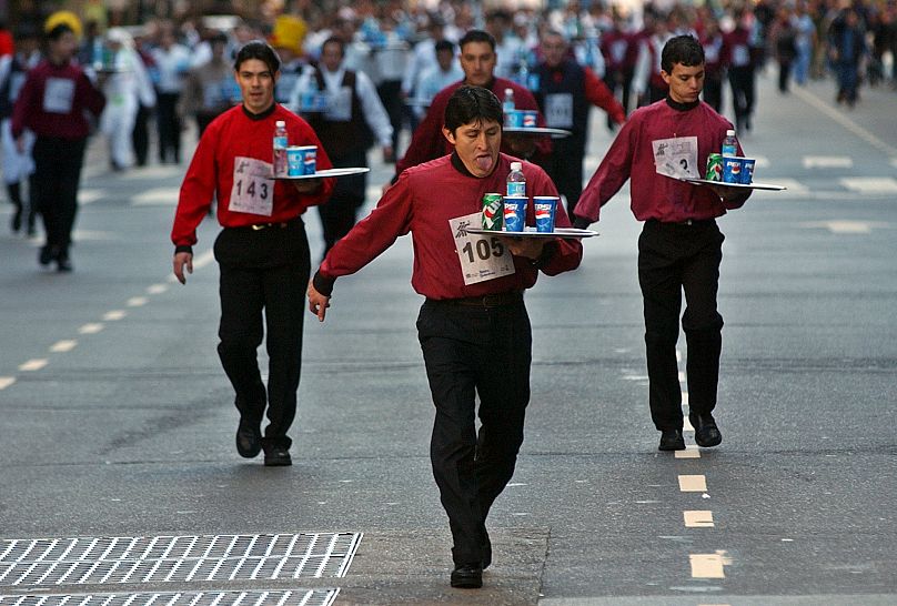 Some 200 waiters participated in a 1600-meter waiter race in downtown Buenos Aires, 2004.