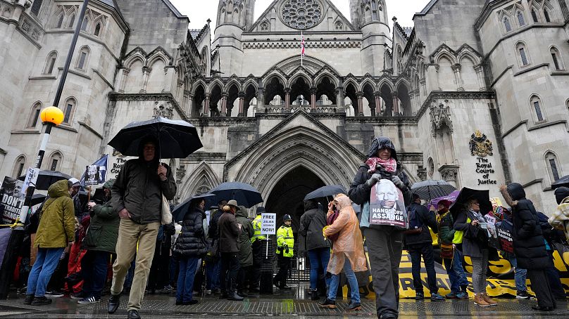 Protesters wait at the Royal Courts of Justice in London, Wednesday, Feb. 21, 2024.