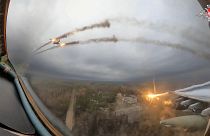 A Russian Su-25 warplane is seen from the cockpit of another such aircraft as they fire rockets on a mission over Ukraine.
