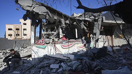 Palestinians inspect the rubble of the Al Daalese family building after an Israeli airstrike in Nusseirat refugee camp, central Gaza Strip, Thursday, Feb. 22, 2024. 