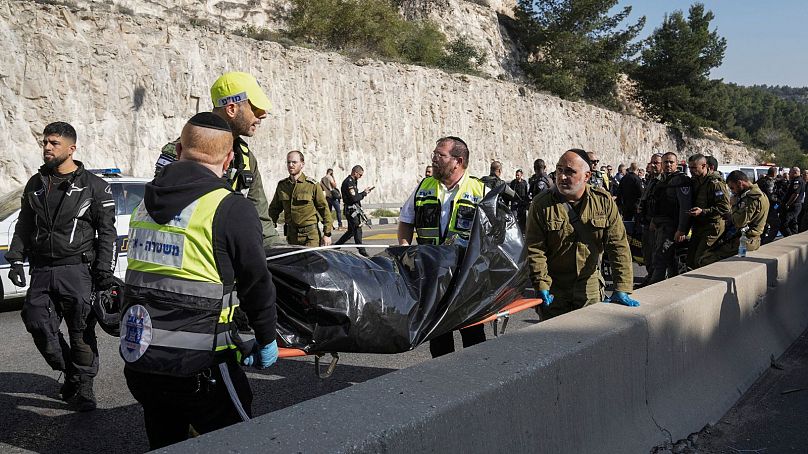 Israeli security forces and members of Zaka rescue service carry a body from the scene of a shooting attack near the West Bank settlement of Maale Adumim, Thursday, Feb. 22.