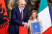 Italy's Prime Minister Giorgia Meloni her Albanian counterpart Edi Rama shake hands after signing a memorandum of understanding on migrant management centres.