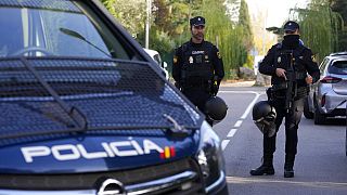 Police officers stand guard as they cordon off the area next to the Ukrainian embassy in Madrid, Spain, Nov. 30, 2022