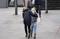 Parents pick up their children after a scene of an attack, at the Wilhelm Doerpfeld School, in Wuppertal, Germany, Thursday, Feb. 22, 2024.