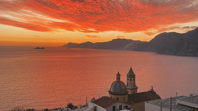 The sun sets on the Amalfi coast, seen from Praiano. 7 November 2022.