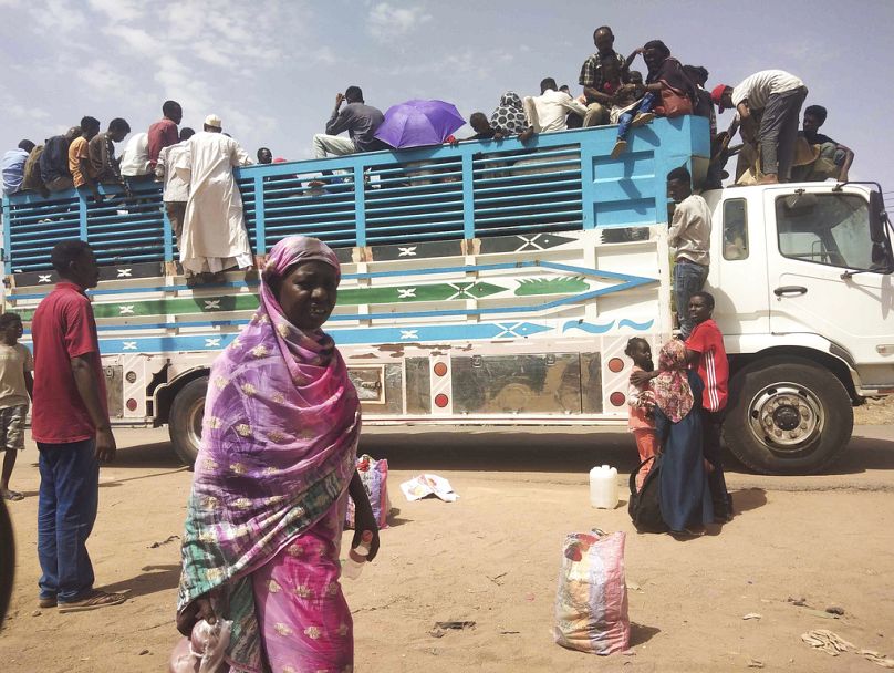 People board a truck as they leave Khartoum, Sudan, 2023.