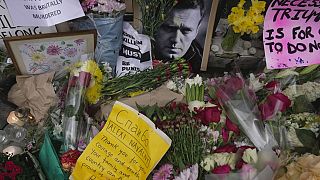 Flowers and portraits are left opposite the Russian embassy, to commemorate the death of Alexei Navalny in London, Monday, Feb. 19, 2024.