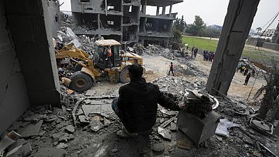  Palestinians search for survivors after an Israeli airstrike on a residential building of the Yaghi family in Deir al Balah, Gaza Strip