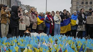People stand at the memorial site for those killed during the war, near Maidan Square in central Kyiv, Ukraine, Feb. 24, 2024.