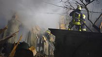 firefighters work on the site of a burning building after a Russian attack in Odesa, Ukraine, Friday, Feb. 23, 2024. (Ukrainian Emergency Service via AP)