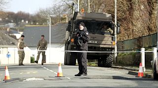 Police and bomb disposal experts stand at the scene near St Michael Avenue following the discovery of a suspected WWII explosive device, in Plymouth, England, Feb. 23, 2024.