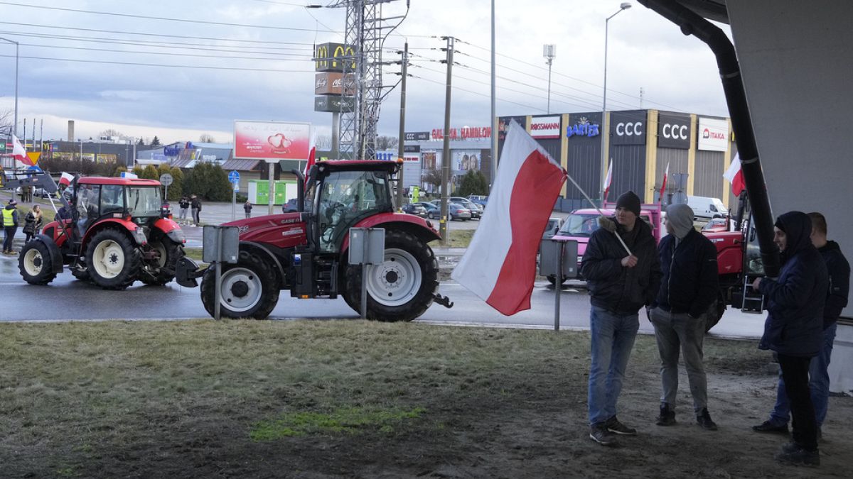 Polish farmers drive tractors in a convoy in Minsk Mazowiecki, Poland, on Tuesday Feb. 20, 2024