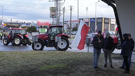 Polish farmers drive tractors in a convoy in Minsk Mazowiecki, Poland, on Tuesday Feb. 20, 2024