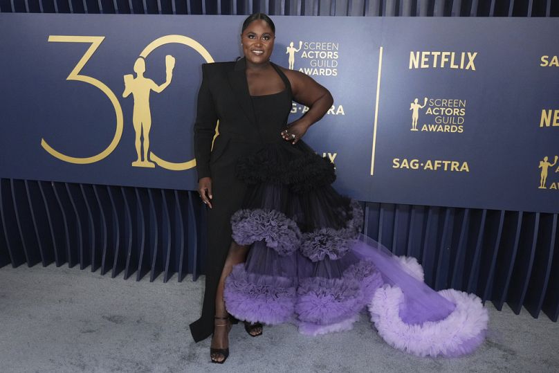 Actor Danielle Brooks, who stars in 'The Color Purple' wears a black and purple Christian Siriano gown to the 30th annual SAG Awards in Los Angeles.