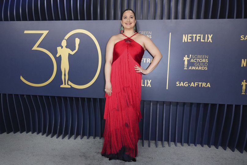Lily Gladstone, winner of the SAG Award for best female performance in a drama film, in a shimmery red gown from Georgio Armani.