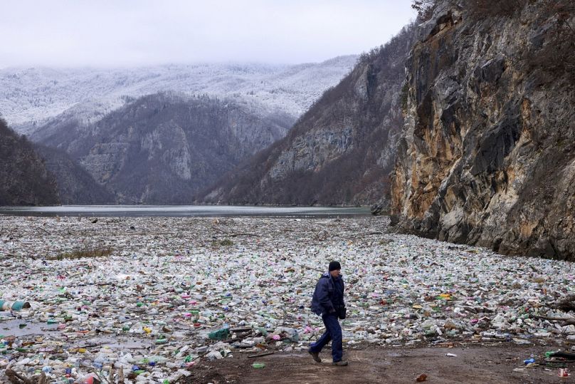 A crane operator walks next to the waste footing in the Drina river near Visegrad, Bosnia.