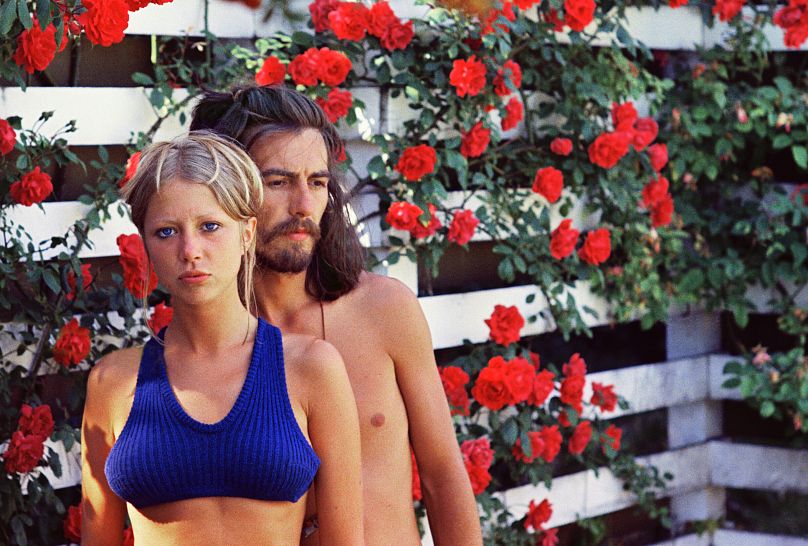 Pattie Boyd and George Harrison posing for a photograph taken by Boyd at their home in Surrey, estimated to sell for 4,000-6,000 pounds.