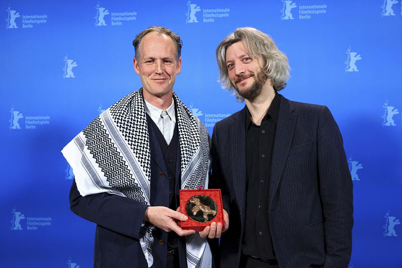 Guillaume Cailleau and Ben Russell pose with the Encounters Best Film Award for "Direct Action"