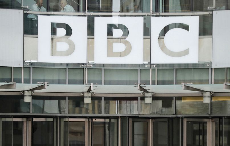 The BBC sign is seen outside the entrance of the headquarters of the publicly funded media organization, July 19, 2017, in London.