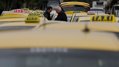 Taxi drivers gather during their rally in Athens, Greece, Tuesday, Feb. 27, 2024. 