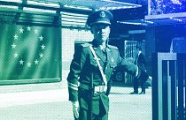 A Chinese paramilitary policeman stands guard at the entrance to the European Union Delegation to China compound in Beijing, October 2023