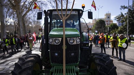 A farmer drives his tractor towards the European Parliament offices during a protest in Madrid, Spain, Monday, Feb. 26, 2024.