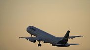 A Lufthansa Airbus A321 takes off from Lisbon at sunrise