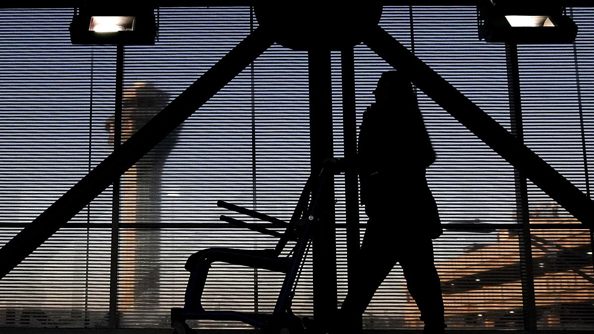 An airline employee transfers a wheelchair to her station at O'Hare International Airport in Chicago, Nov. 23, 2022. 