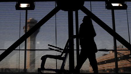 An airline employee transfers a wheelchair to her station at O'Hare International Airport in Chicago, Nov. 23, 2022. 