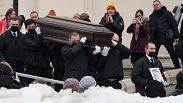 Workers carry the coffin and a portrait of Russian opposition leader Alexei Navalny out of the Church of the Icon of the Mother of God Soothe My Sorrows, in Moscow, Russia, Fr