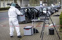 A forensics officer works near a car in front of the Von D'ring barracks in Rotenburg, Germany, Friday March 1, 2024.