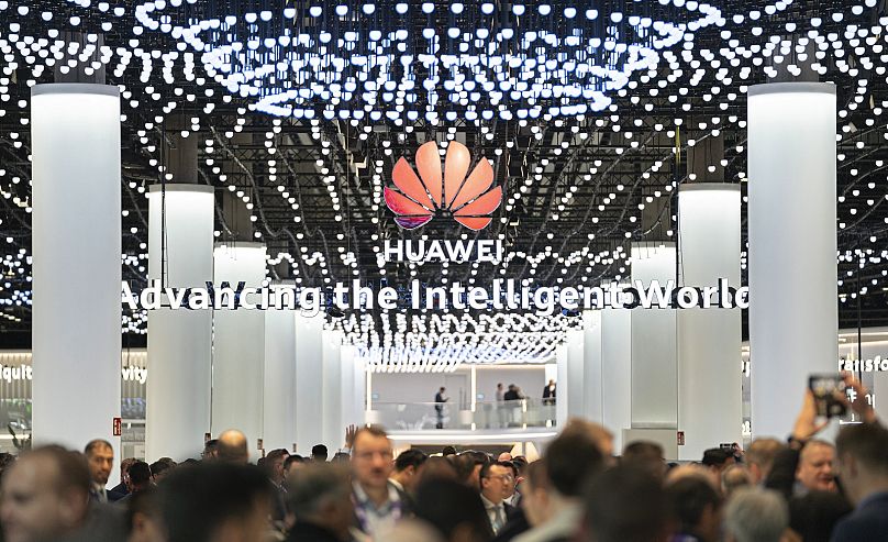 Visitors walk through Huawei stand during the Mobile World Congress 2024 in Barcelona, Spain, Monday, February 26, 2024.