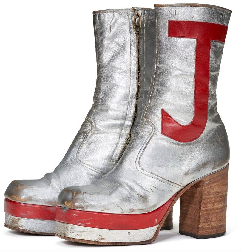 A pair of silver leather tall platform boots, worn by John during numerous performances throughout the 1970's