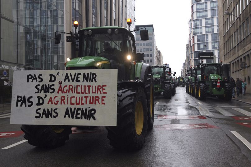 Tractors drive in formation as they leave the city after a protest of farmers outside a meeting of EU agriculture ministers in Brussels, February 2024