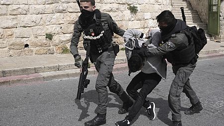 Israeli Border Police detain a Palestinian man ahead of Friday prayers at the Al-Aqsa Mosque compound in the Old City of Jerusalem, Friday, March 1, 2024.