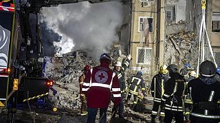 emergency workers clear the rubble on the site of a destroyed multi-store building after a Russian attack on residential neighbourhood in Odesa, Ukraine, 2/3/24.