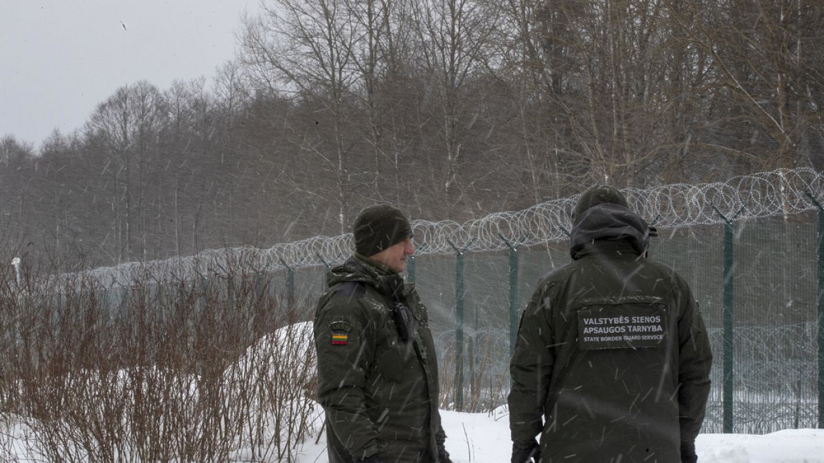 FILE - Members of the Lithuania State Border Guard Service on the border with Belarus 