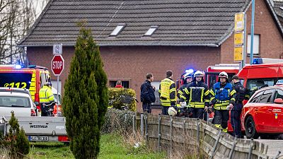 Police and fire department personnel stand by a retirement home after a fire broke out during the night, in Bedburg-Hau in the western German state of North Rhine-Westphalia.