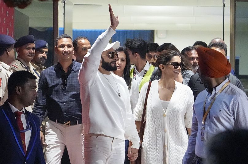 Bollywood stars Ranveer Singh, left and Deepika Padukone arrive at airport to attend the pre-wedding celebrations.
