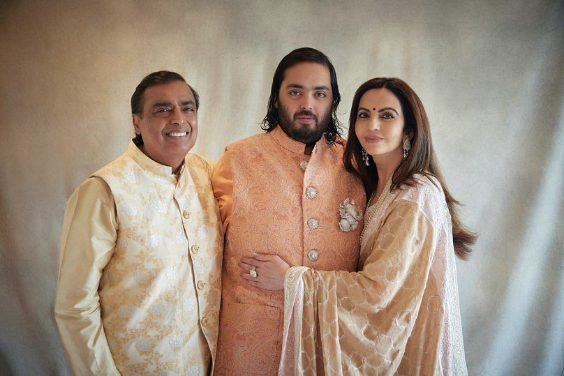 Billionaire industrialist Mukesh Ambani, son Anant and wife Nita, posing for a photograph as guests gather to celebrate Anant's wedding in Jamnagar, India.