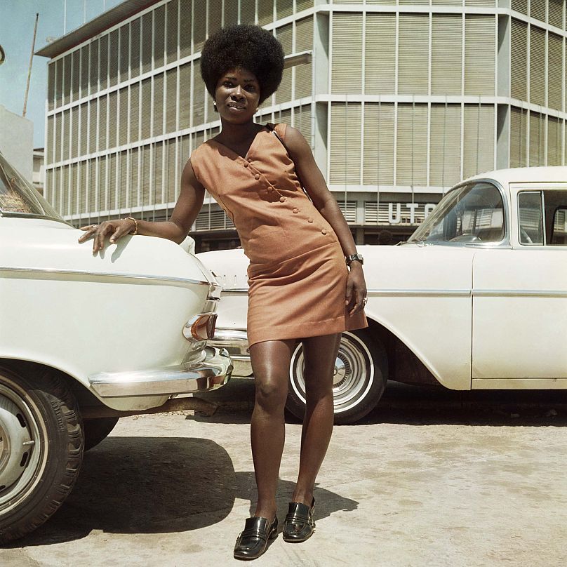 Sick Hagemeyer shop assistant as a seventies icon posing in front of the United Trading Company headquarters, Accra, 1971