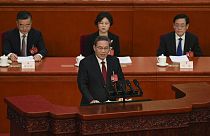 Chinese Premier Li Qiang, center, speaks during the opening session of the NPC at the Great Hall of the People in Beijing, China, Tuesday, March 5 2024