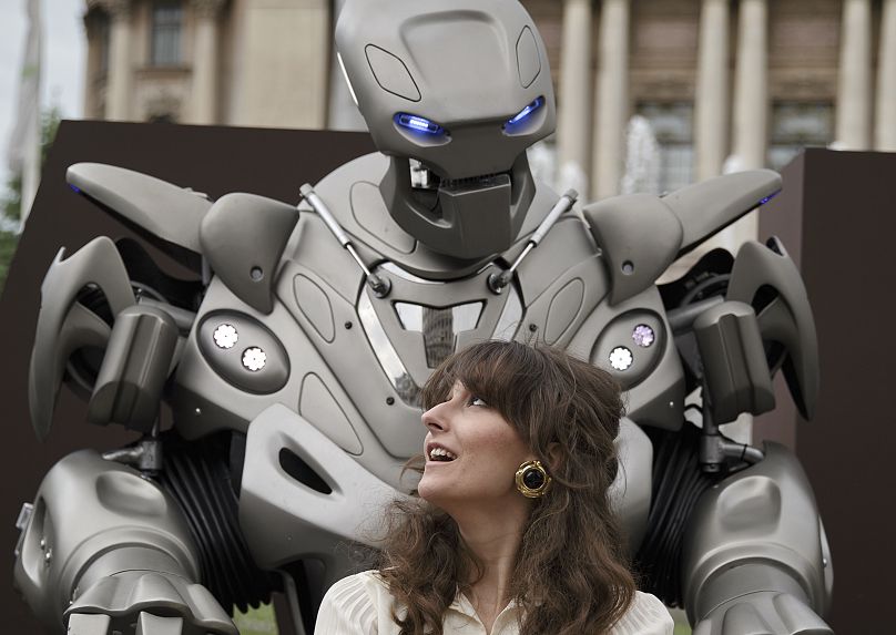 A woman gets her photo taken with Titan the Robot, in Bucharest, Romania, Monday, May 11, 2015