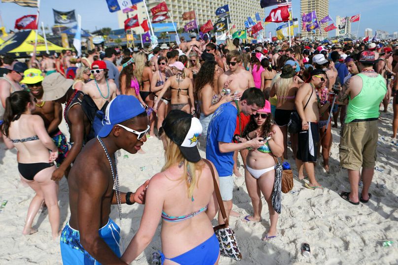 In this file photo, party goers fill the sand behind Club La Vela and Spinnaker Beach Club during the fourth week of spring break in Panama City Beach