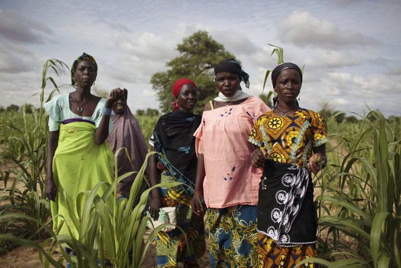 In this picture taken Thursday, July 19, 2012, young girls stand in a field of millet outside the remote village of Hawkantaki, Niger.