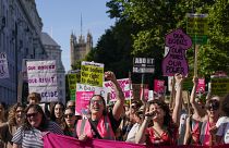  Demonstrators hold placards as they attend a march in support of the Abortion Rights group, in London, on July 9, 2022.