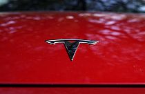 A Tesla logo is seen on a vehicle on display in Austin, Texas, Wednesday, Feb. 22, 2023. 