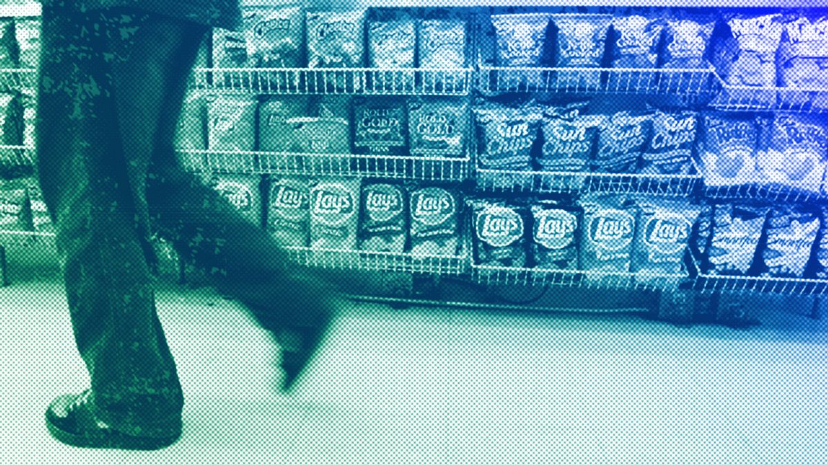 A convenience store customer walks past a shelf of salty snacks in Boston, July 2005