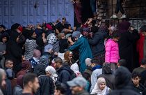 Palestinian crowds struggle to buy bread from a bakery in Rafah, Gaza Strip, Sunday, Feb. 18, 2024.